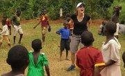 Liz Byron-Scott from Kain Lawyers playing soccer with villagers in Uganda